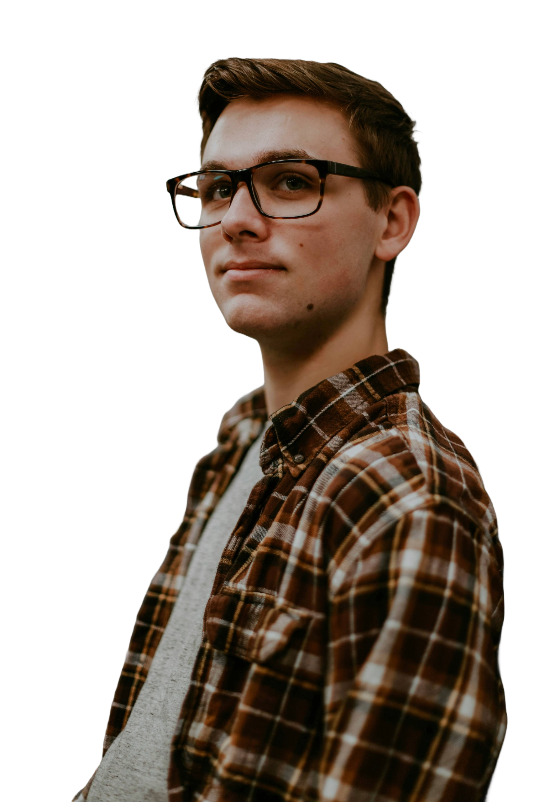 Young man with glasses in shirt looking into the distance.