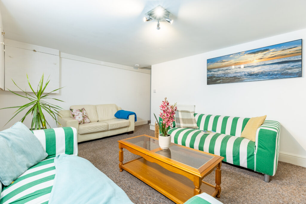 Cozy living room with TV and comfortable sofa.