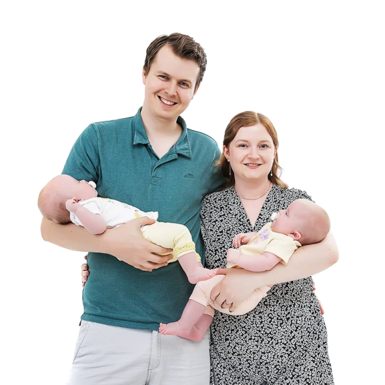 Fred of Cheltenham Student Homes standing with his wife and two children in their arms.