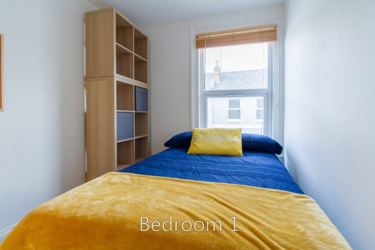 Bedroom 1 at 24 Granville Street with a double divan bed and large storage unit.